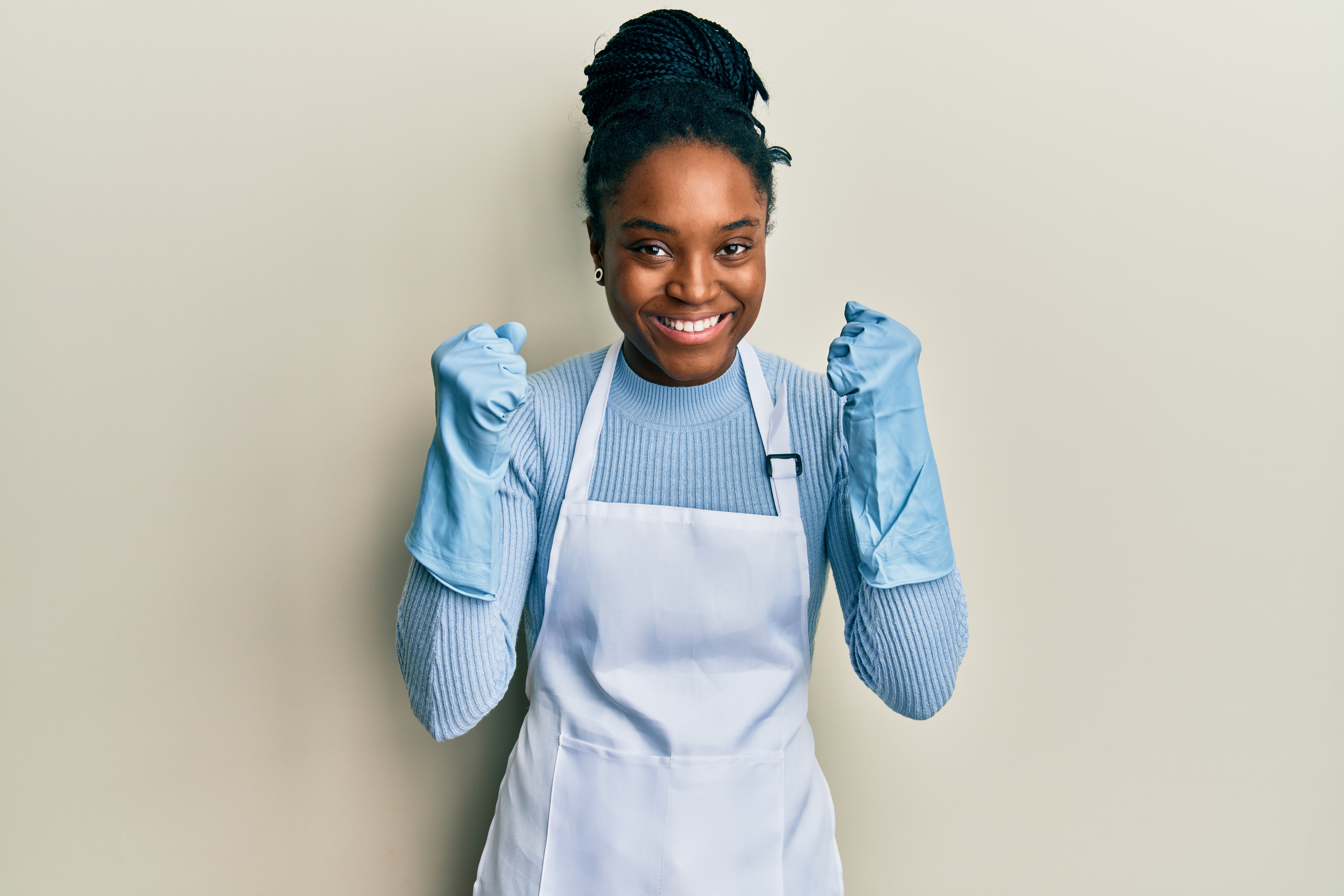 A B&M cleaner wiping down a kitchen worktop